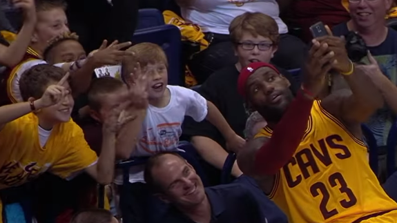LeBron James Takes a Mid-Game Selfie with Fans